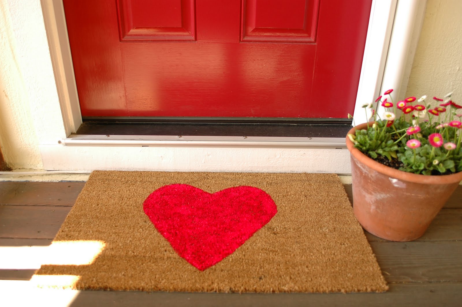 Photo of a red front door with a matching doormat for an article about improving curb appeal.