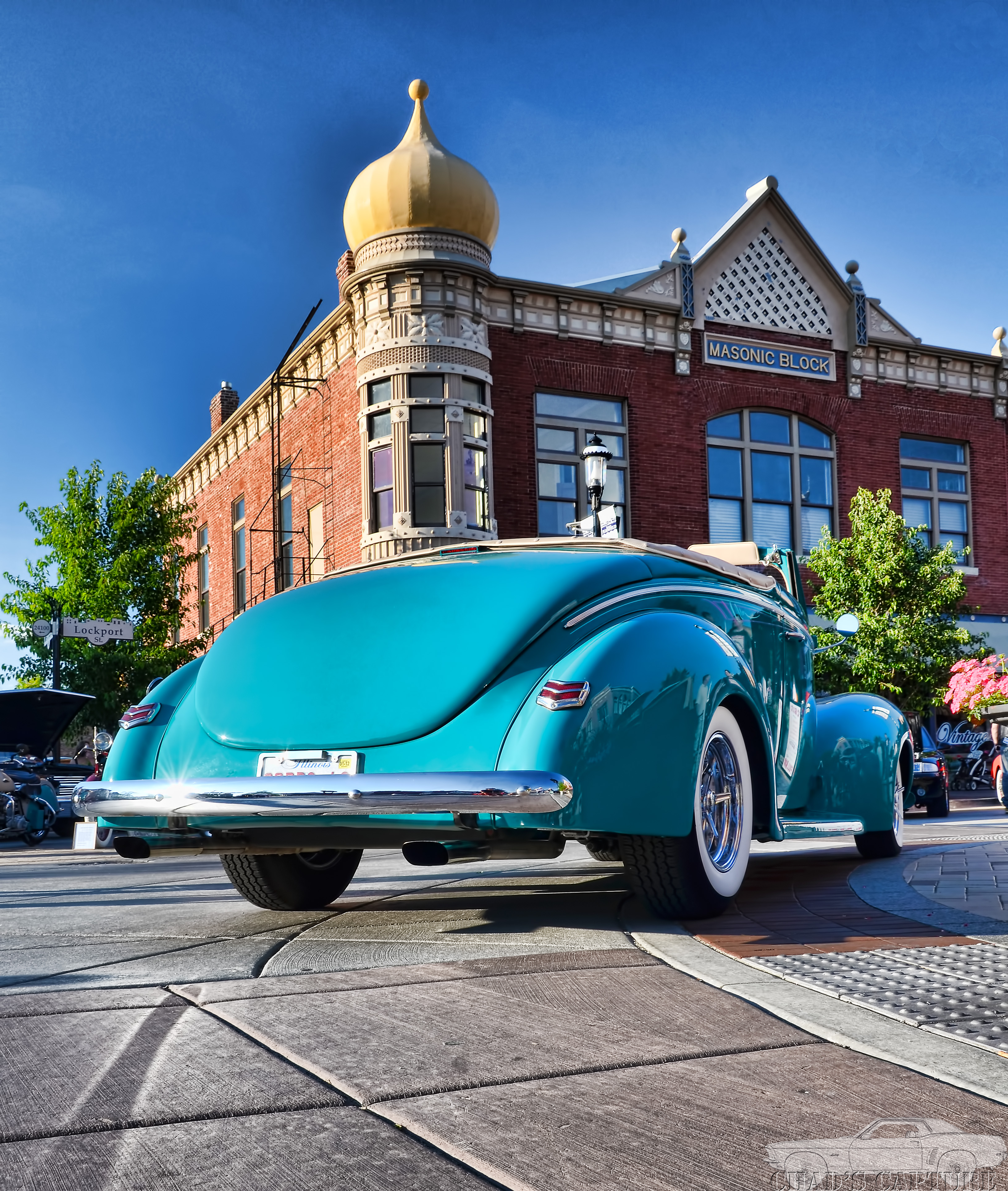 Photo of a classic car driving through downtown Plainfield.