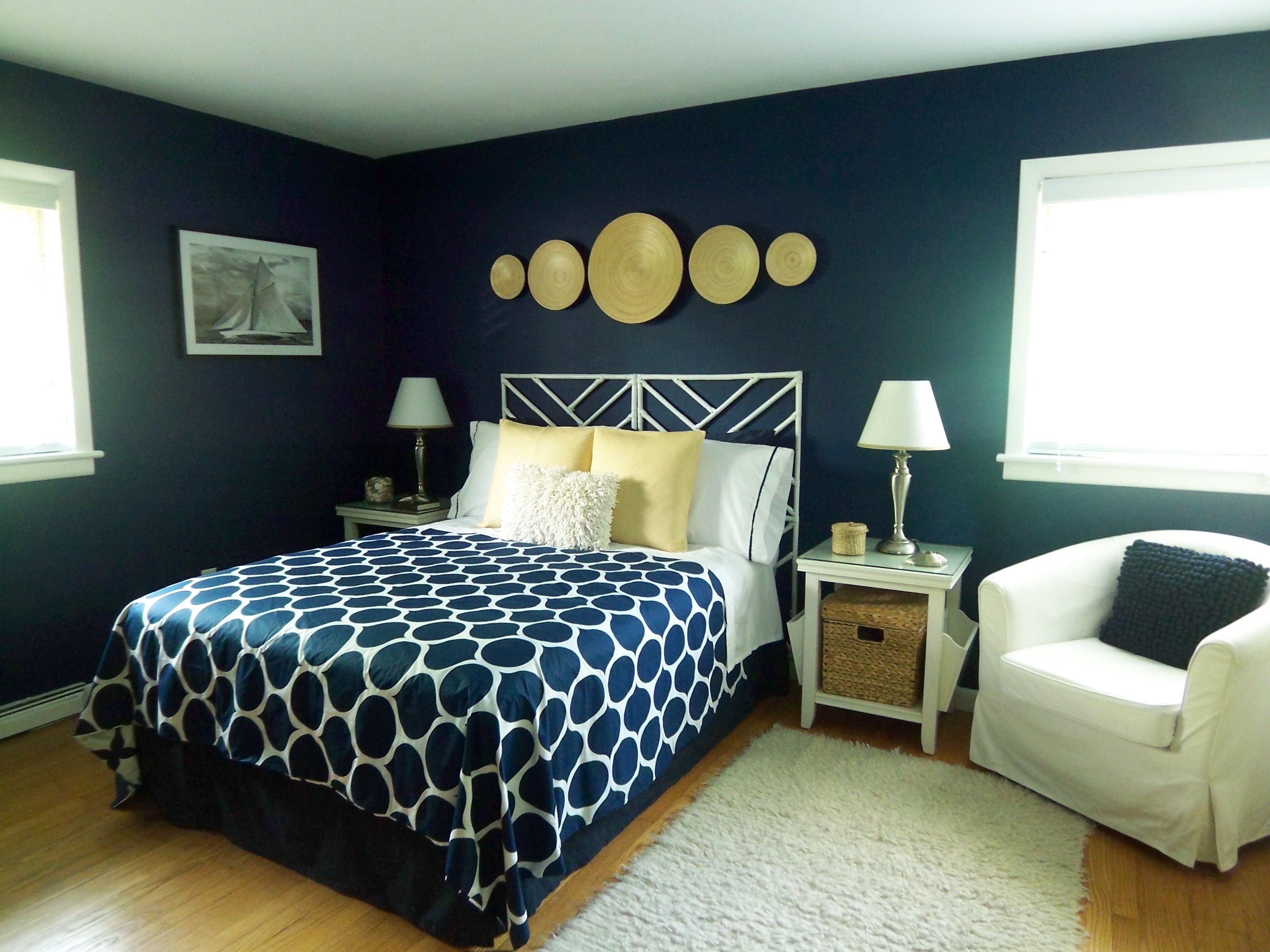 Modern navy blue bedroom as an example of spring home decor trends.