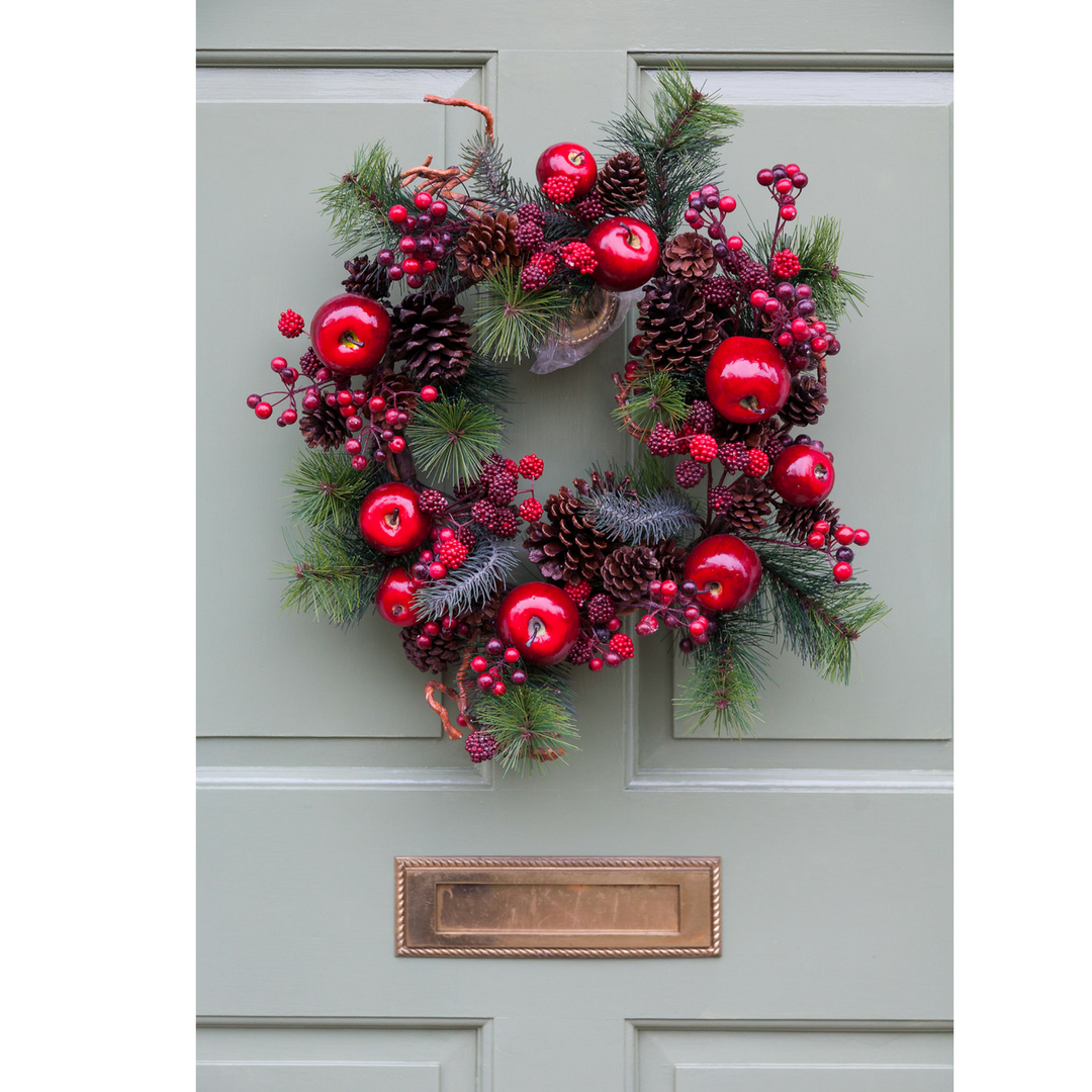 Photo of a front door with a wreath on it for an article about the color of a front door and what it says about the homeowner.