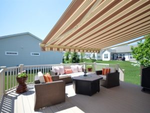 Gorgeous backyard complete with sun shade and a deck in a Shorewood Glen Del Webb home.