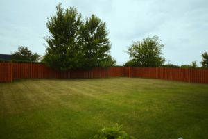 Large private fenced backyard of a home for sale in Farmingdale Village.