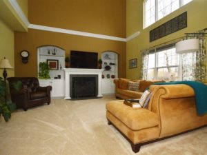 Two story family room with fireplace and built-ins of 1310 Callawaya N Drive Shorewood.