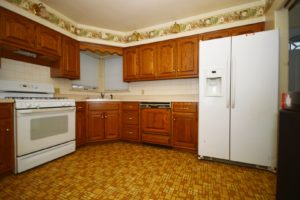 The kitchen in 1612 Dearborn Street Crest Hill features a corner sink and a backsplash.