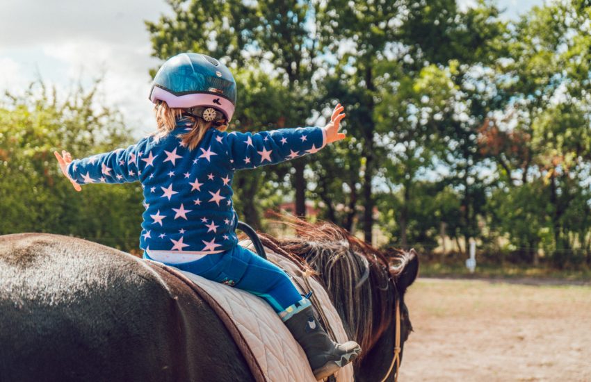 Child riding a horse; horse riding is one of the activities offered this summer in the Plainfield Parks special interest camps.