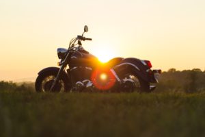 A motorcycle against a sunset; cruise nights are just one of the fun Plainfield summer activities planned.