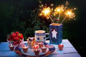 Patriotic picnic spread with sparklers, candles, and more. The Plainfield fireworks are happening soon.