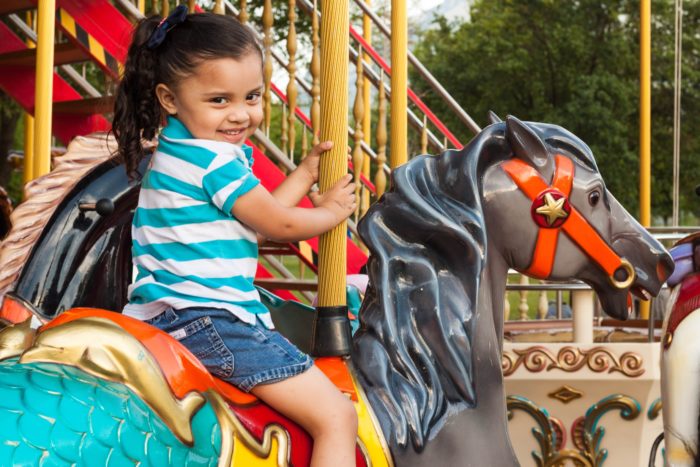 Little girl on a carousel; the Plainfield Fest 2019 is happening soon.