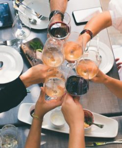 Wine glasses doing a "cheers"; one of the upcoming Plainfield fall events is a wine and cheese tasting.