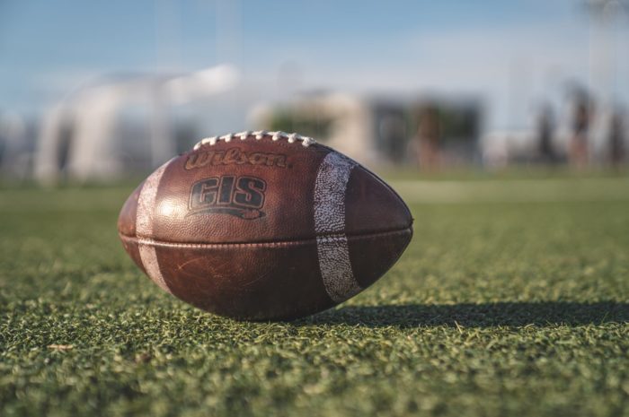 A football resting on a field; a Chicago Bear alumni appearance is one of the November 2019 events happening.