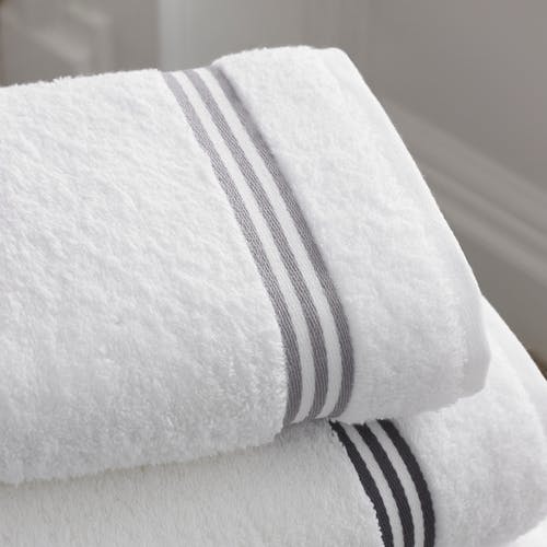 Closeup of white and gray stripe hand towels; hand towels are important home staging accessories.