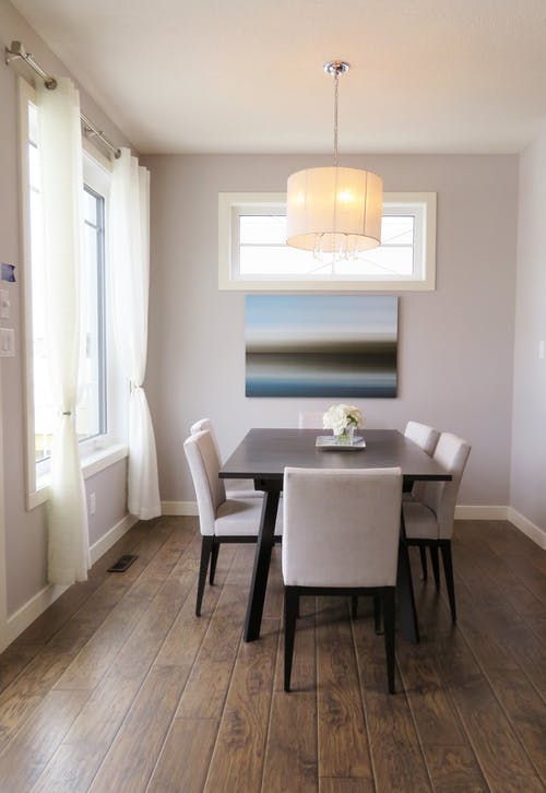 A dining room with art hanging on the wall; wall art are great home staging accessories.