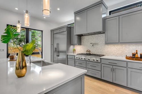 Gorgeous updated kitchen with gray cabinetry; there are several FAQ for home sellers that should be answered before selling.