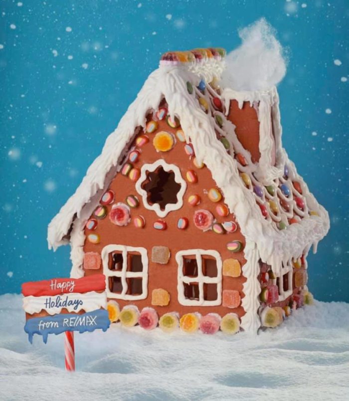 Gingerbread house with a RE/MAX sign; winter homebuying has many advantages. 
