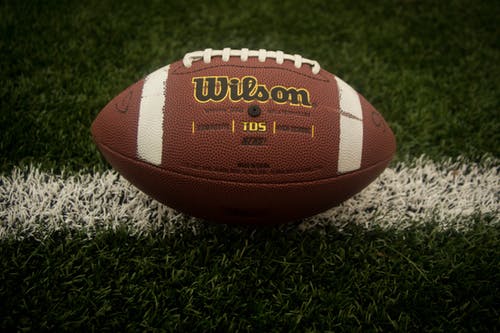 Close up of a football on a field; football fans are looking forward to Super Bowl 2020 and there are many local events.