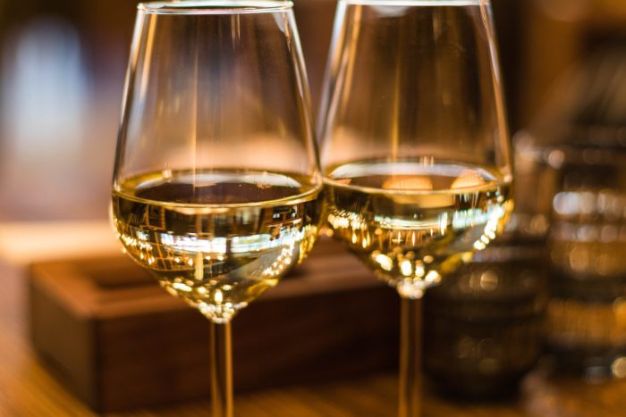 Two wine glasses on a table; a wine and trivia event is one of the winter 2020 events happening in Plainfield.
