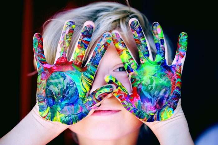 Child with paint all over their hands.