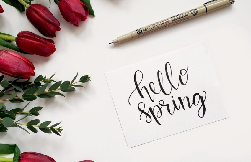 A note saying hello spring with some tulips around it; the spring market for real estate is coming up soon.