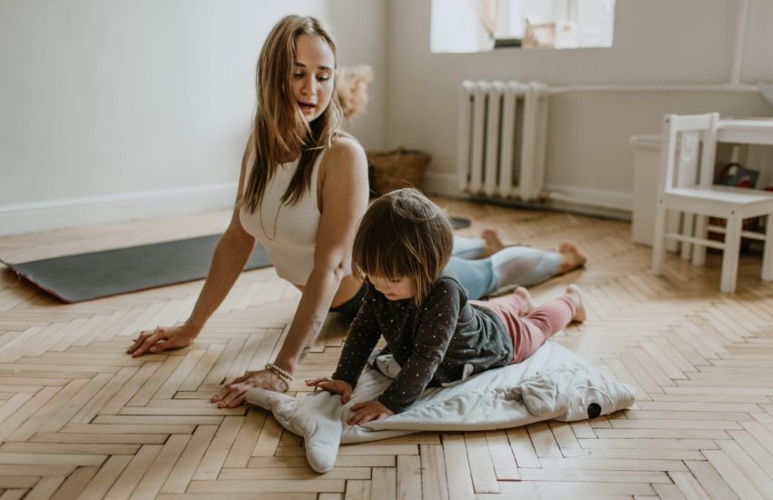Mother and daughter exercising at home to practice self care.