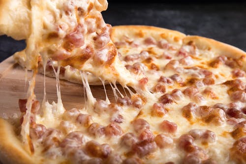 A closeup of a cheesy pizza.