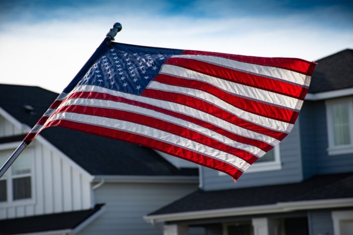 American flag flying between two homes in a neighborhood.