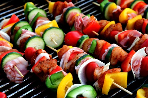 Close up shot of beef and vegetable kabobs on the grill.