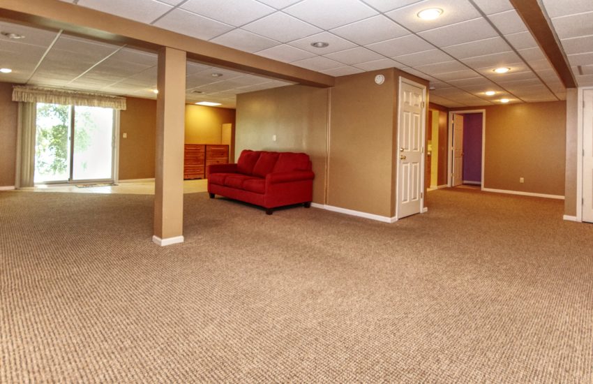 Large second family room in walk-out basement opens to covered patio. in Joliet home.