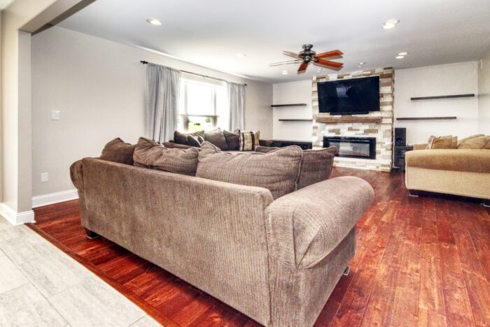 Family room boasts brick fireplace and hardwood floors in Manhattan home!