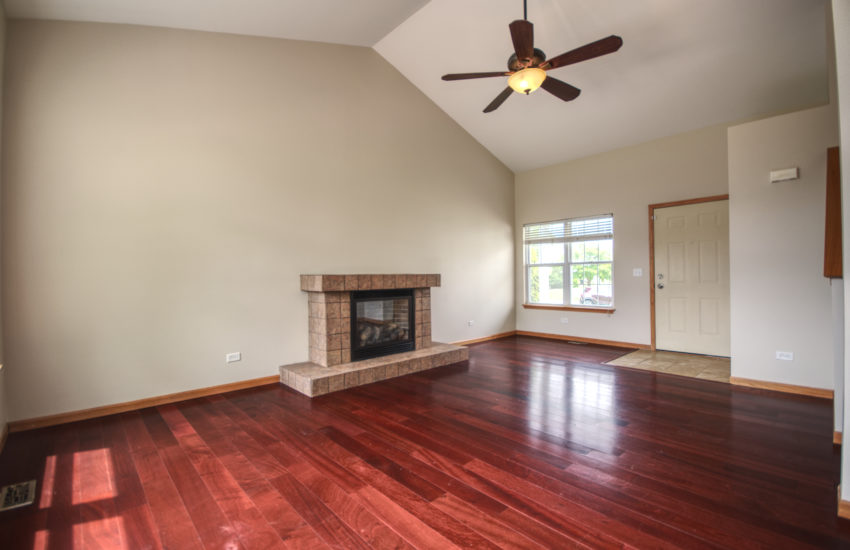 2 Story Living Room features a tile fireplace with built in mantle!