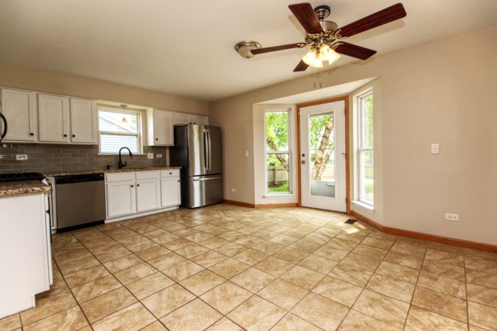 Kitchen with Bay View door to Paver Patio in Plainfield home.