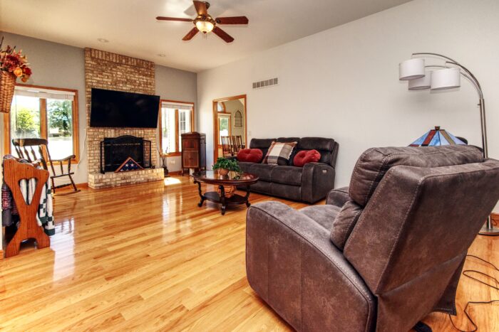 Great room has a floor to ceiling brick fireplace in this home in River Bluff Estates.