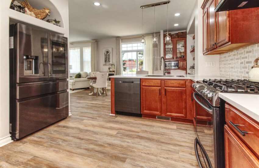 Gourmet Kitchen features custom cabinets, quartz counters, pantry,& farm sink!